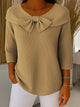 Women's ribbed sweater top with boat neckline and front bow