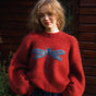 Women's red crew neck jumper with blue dragonfly motif and long sleeves