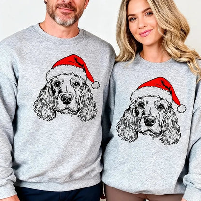 Unisex grey Christmas sweatshirt with dog Santa hat design, shown on family members around decorated kitchen