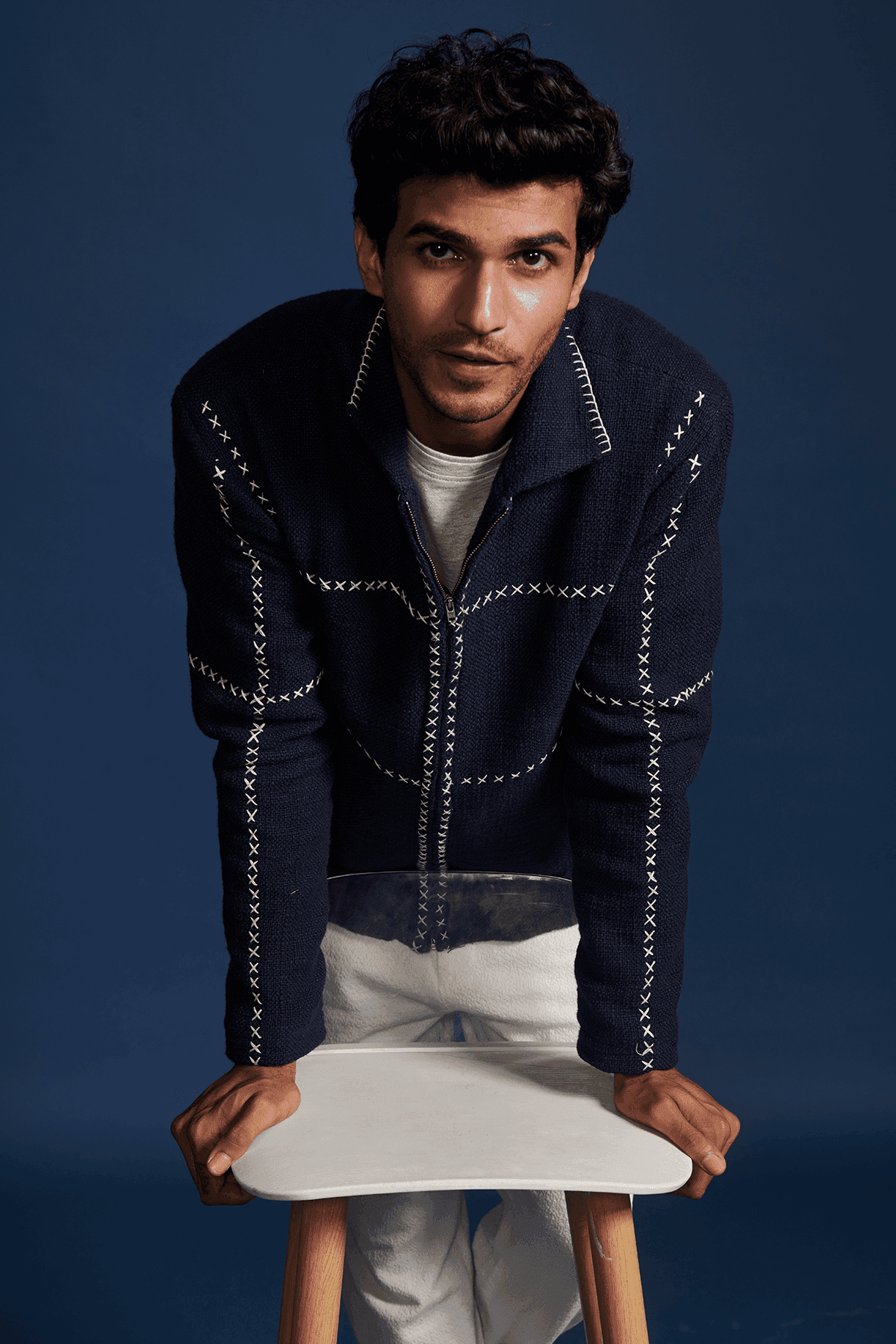 Men's navy zip jacket with stand collar and contrasting cross-stitch detailing