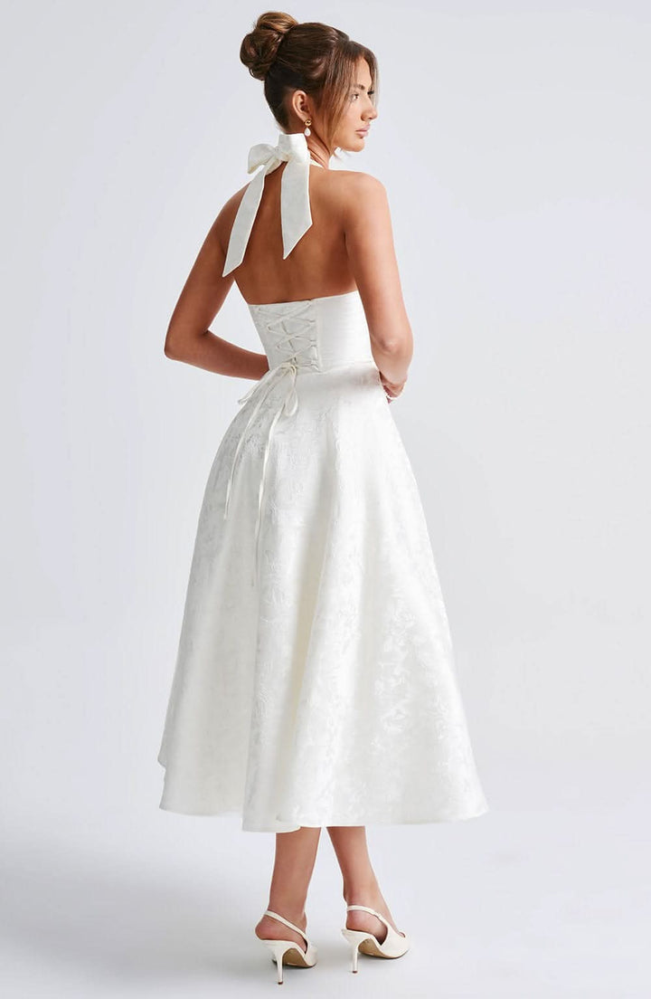 Women's halter midi dress with V-neckline and full A-line skirt in white and pale yellow