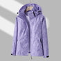 Women's hooded leaf print rain jacket with long sleeves and zipped pockets