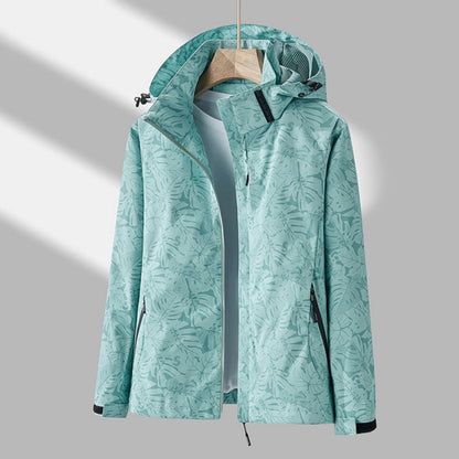 Women's hooded leaf print rain jacket with long sleeves and zipped pockets