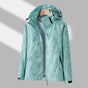 Women's hooded leaf print rain jacket with long sleeves and zipped pockets