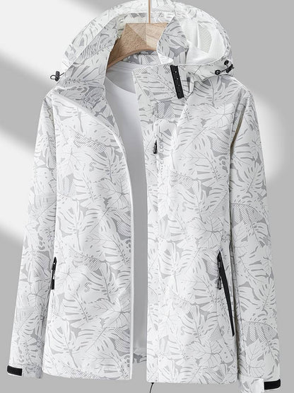 Women's hooded leaf print rain jacket with long sleeves and zipped pockets
