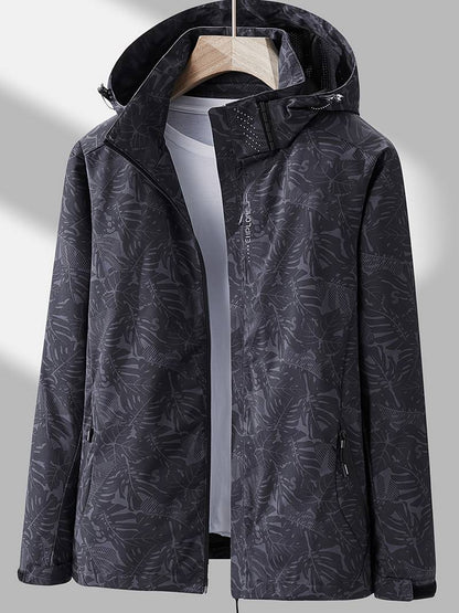 Women's hooded leaf print rain jacket with long sleeves and zipped pockets