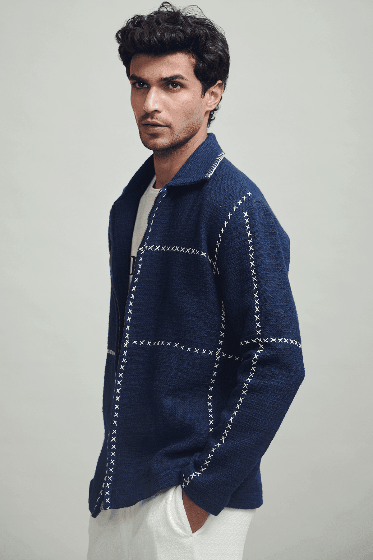 Men's navy zip jacket with stand collar and contrasting cross-stitch detailing