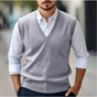 Men's sleeveless V-neck sweater vest layered over a white collared shirt