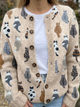 Beige knit cardigan with an all-over cat print and button front