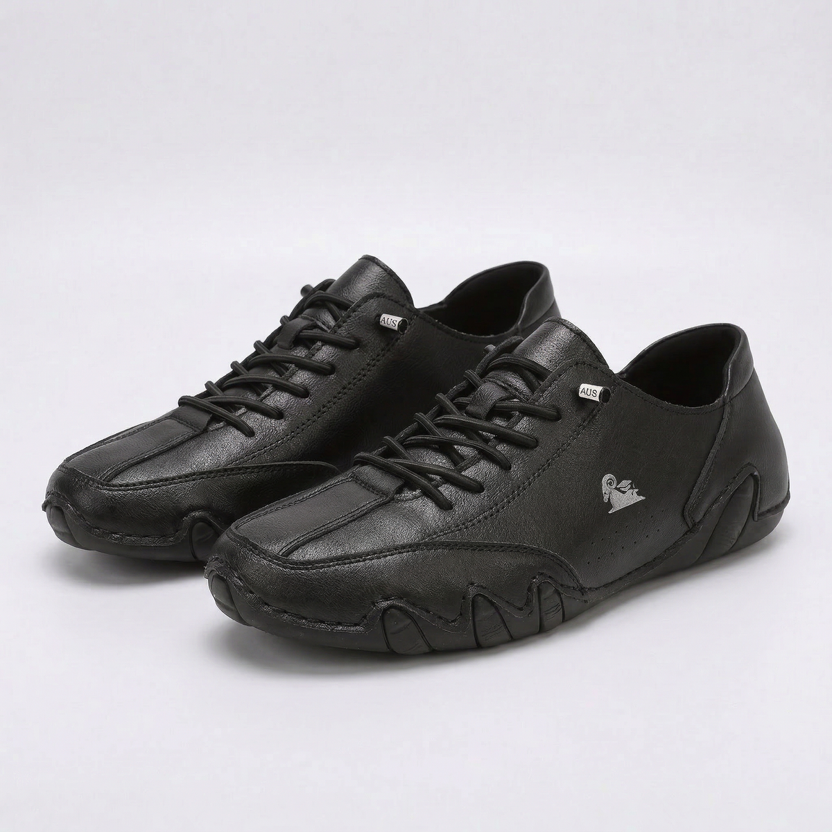 Low-top lace-up sneakers with round toes, stitched panels and segmented soles