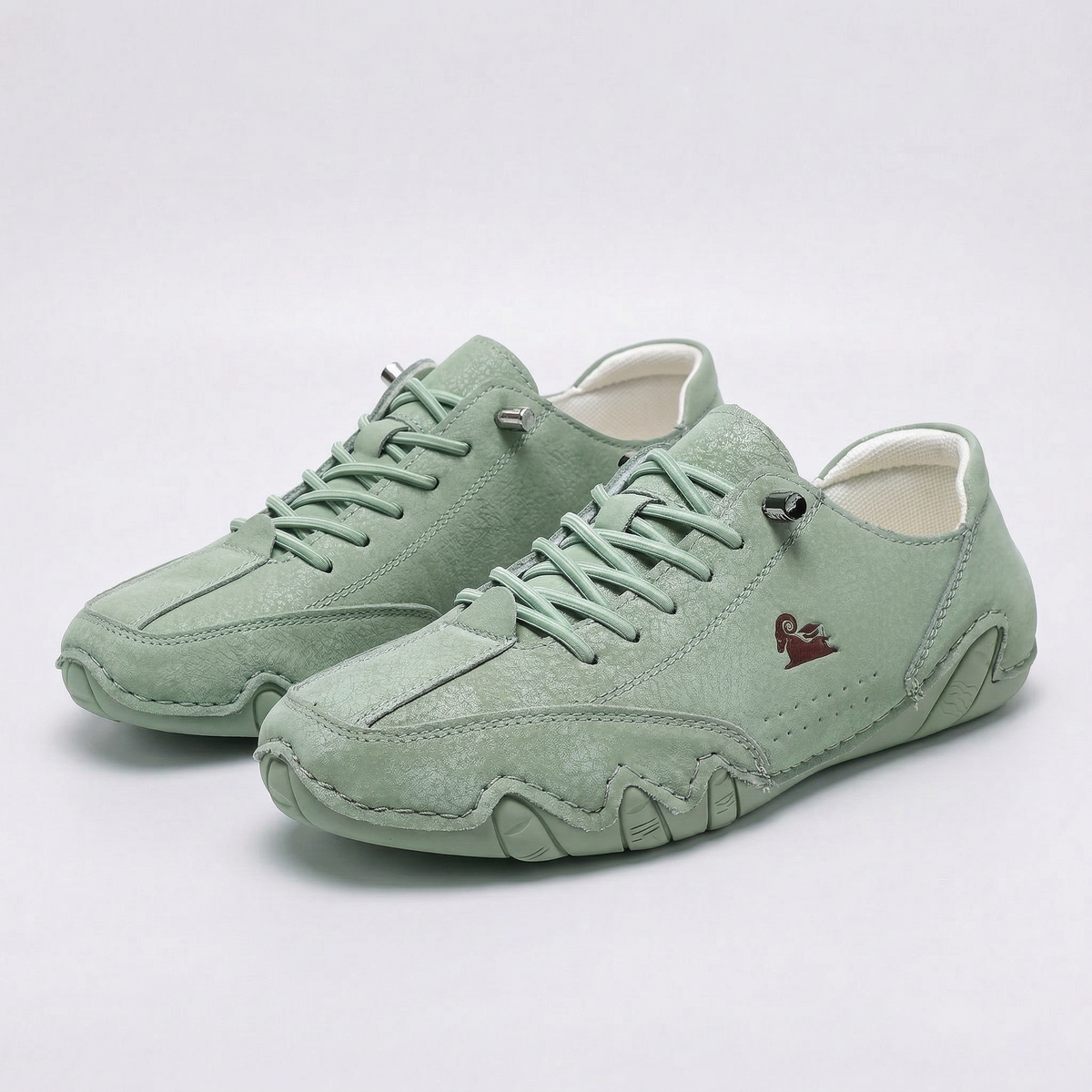 Low-top lace-up sneakers with round toes, stitched panels and segmented soles