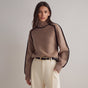 Women's oversized turtleneck sweater with contrast piping and long sleeves