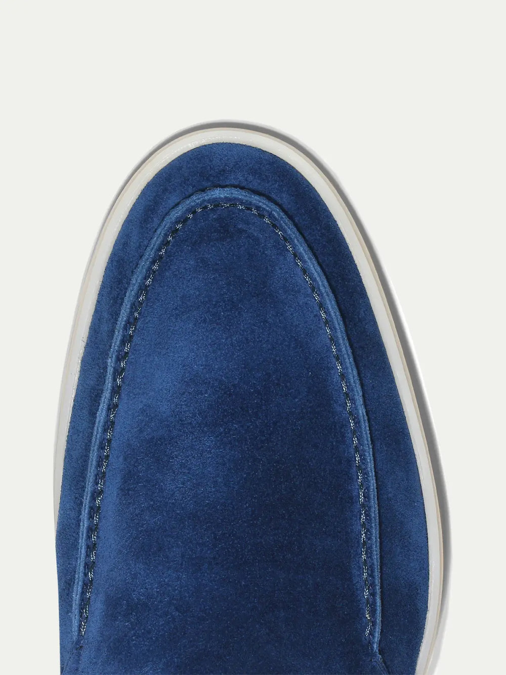 Men's blue slip-on loafers with textured finish and off-white flat soles