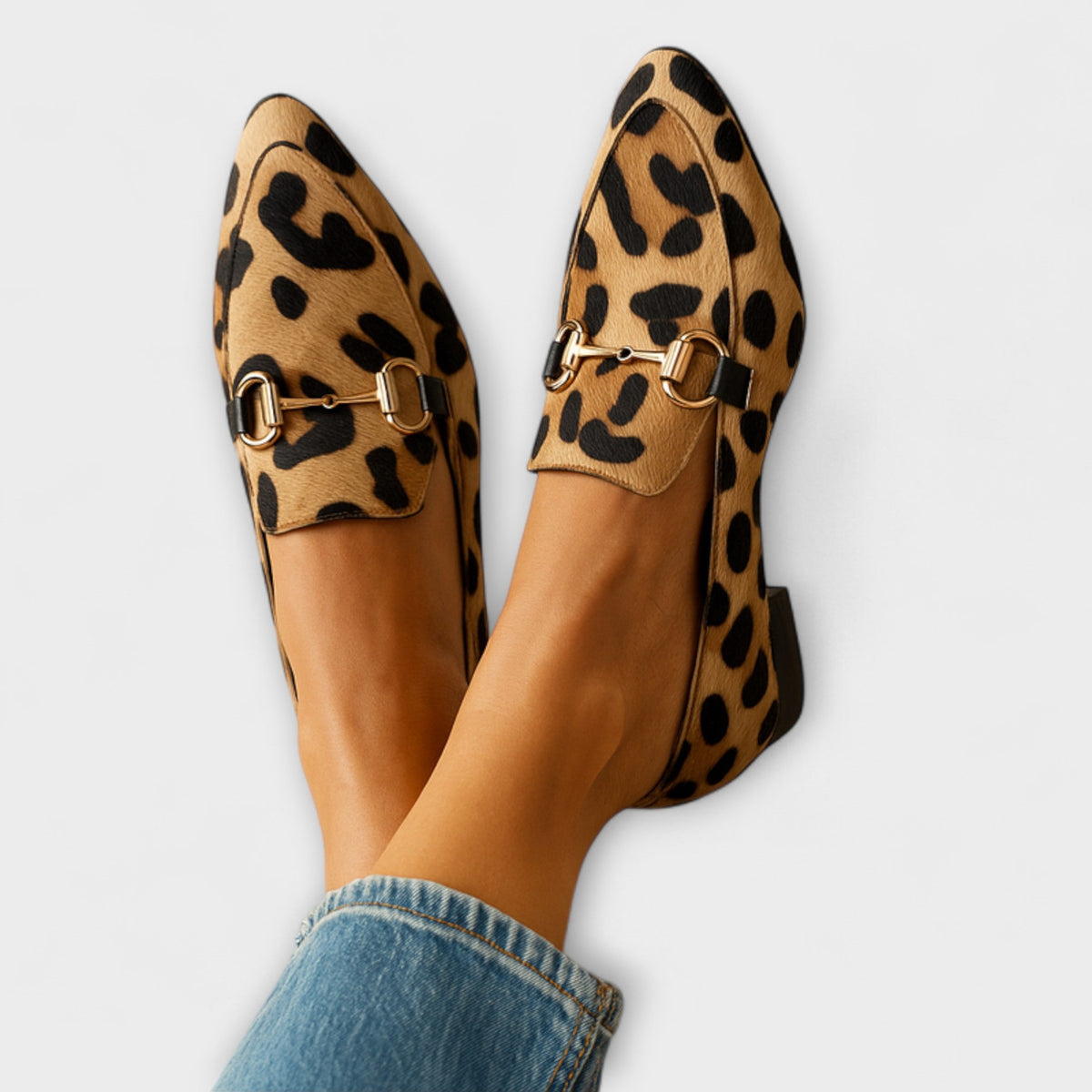 Tan and black leopard print pointed-toe loafers with metal horsebit detailing