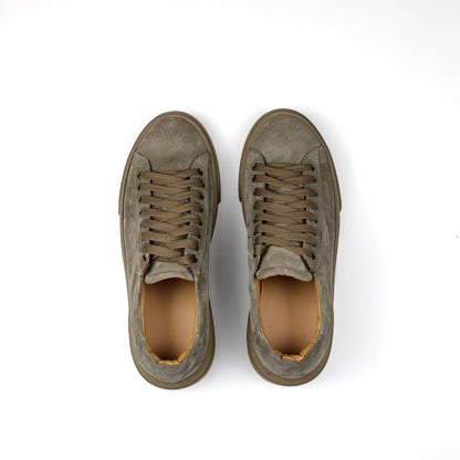 Taupe low-top lace-up sneakers with stitched panels and platform soles