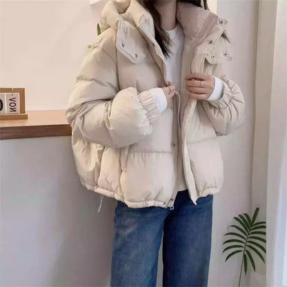 Women's hooded quilted puffer jacket with high neck, long sleeves and zip front
