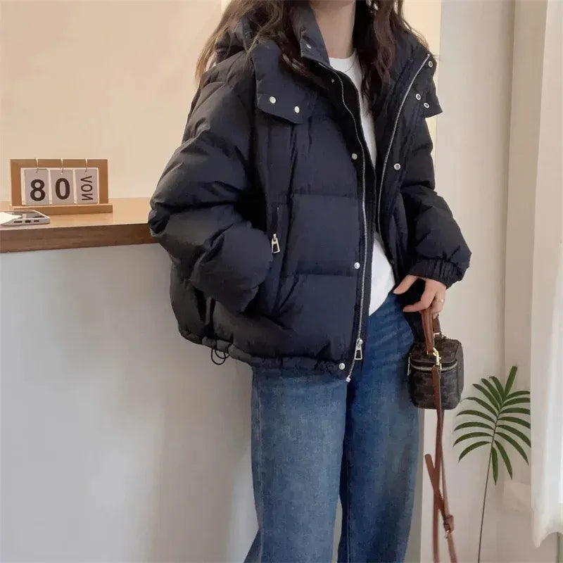 Women's hooded quilted puffer jacket with high neck, long sleeves and zip front