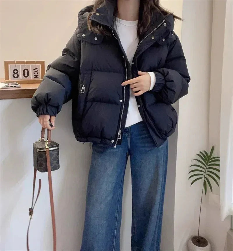 Women's hooded quilted puffer jacket with high neck, long sleeves and zip front