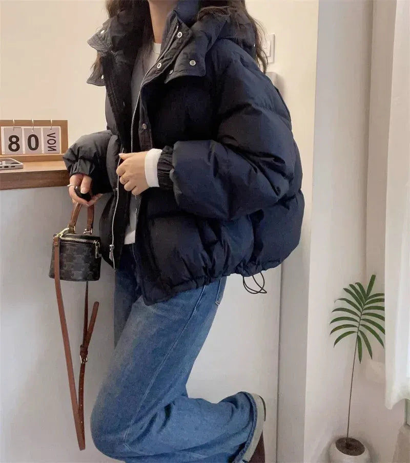 Women's hooded quilted puffer jacket with high neck, long sleeves and zip front