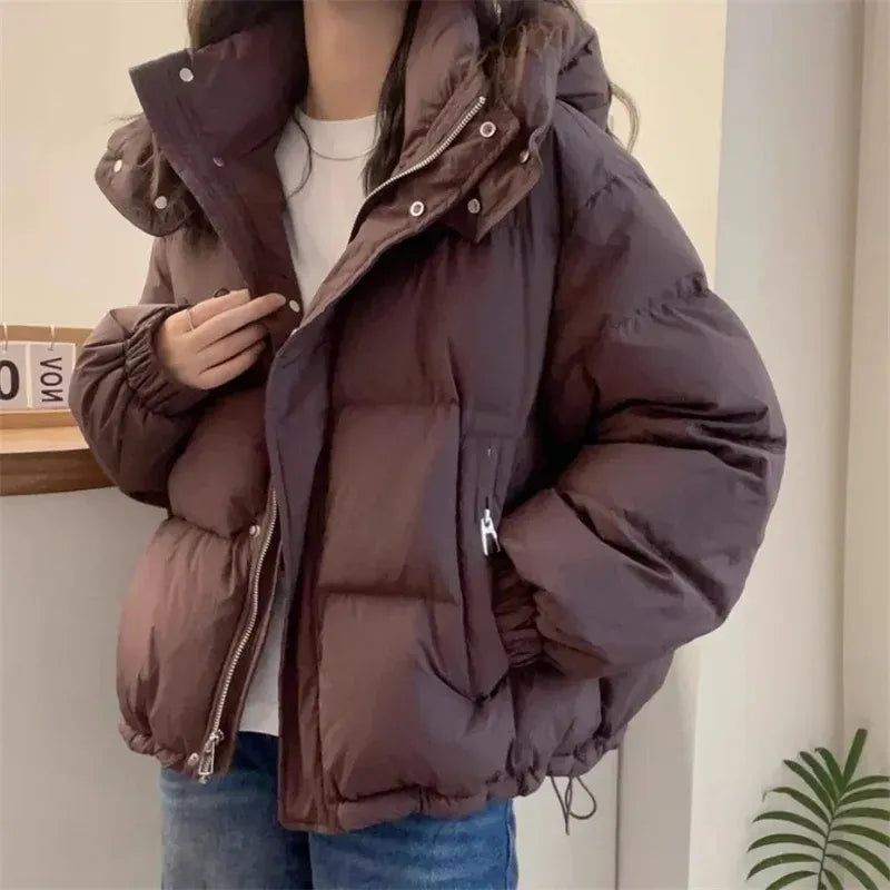 Women's hooded quilted puffer jacket with high neck, long sleeves and zip front