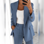 Women's tailored blazer and straight-leg trouser suit set with lapels and flap pockets