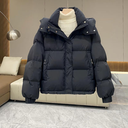 Women's hooded quilted puffer jacket with high neck, long sleeves and zip front