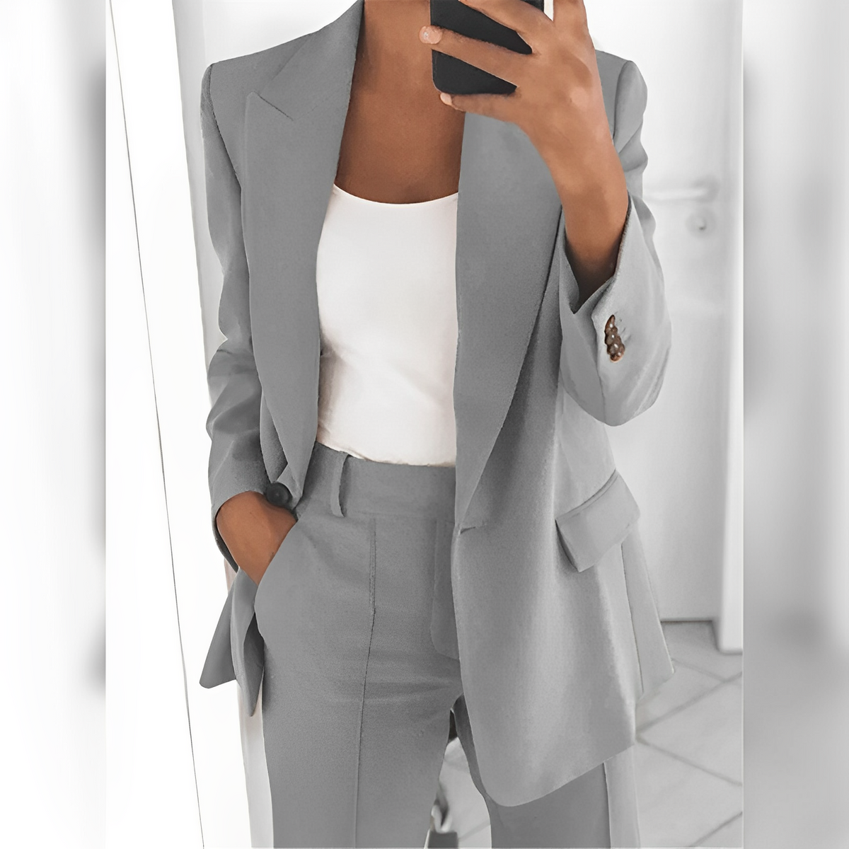 Women's tailored blazer and straight-leg trouser suit set with lapels and flap pockets