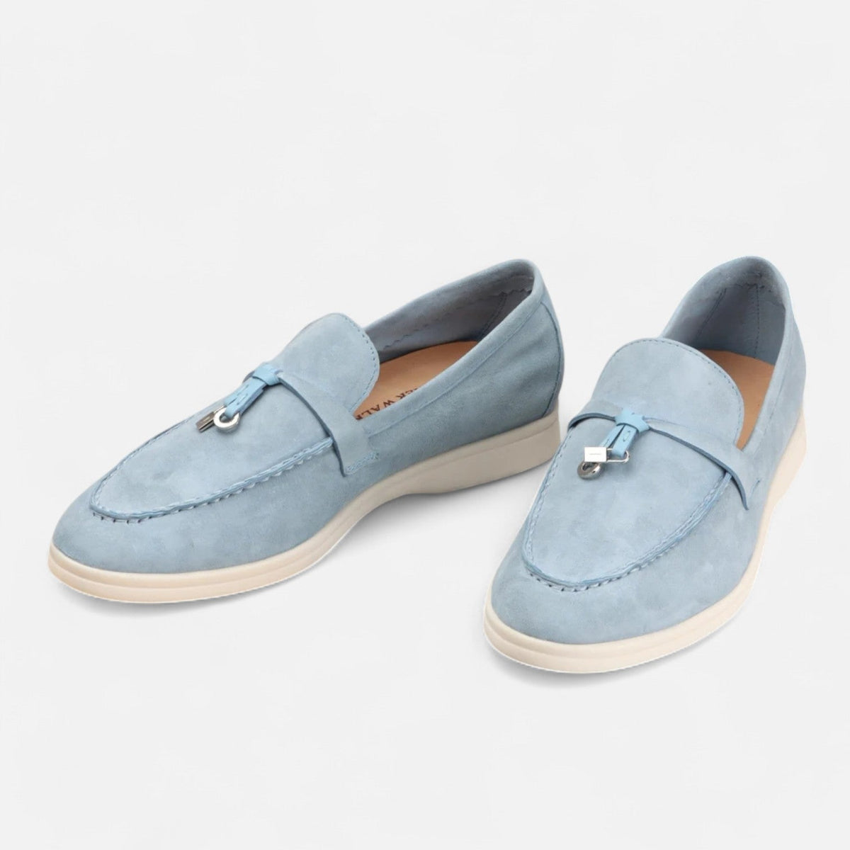 Men's textured slip-on tassel loafers with rounded toes and flat light-coloured soles