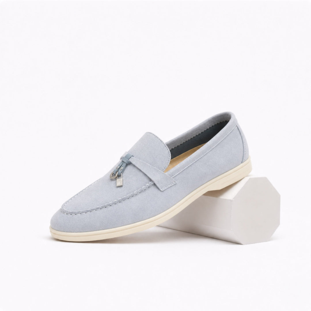 Women's slip-on loafers with flat soles, stitched toes and metal vamp trim