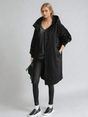 Woman wearing a longline hooded button-front trench coat with patch pockets