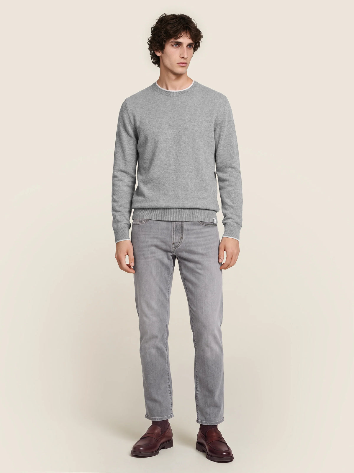 Gray crew neck knit sweater with long sleeves and ribbed trims