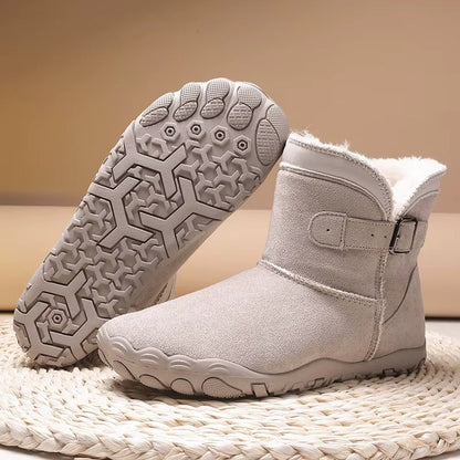 Ankle-height barefoot winter boots with faux fur lining, buckle strap and textured tread