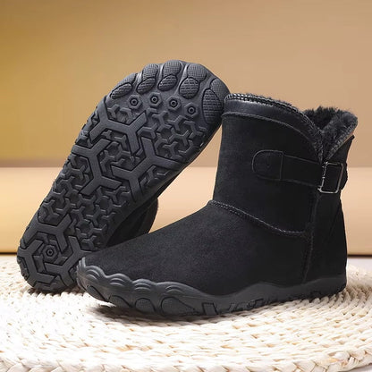 Ankle-height barefoot winter boots with faux fur lining, buckle strap and textured tread