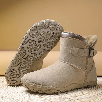 Ankle-height barefoot winter boots with faux fur lining, buckle strap and textured tread