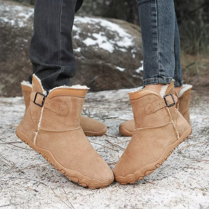 Ankle-height barefoot winter boots with faux fur lining, buckle strap and textured tread