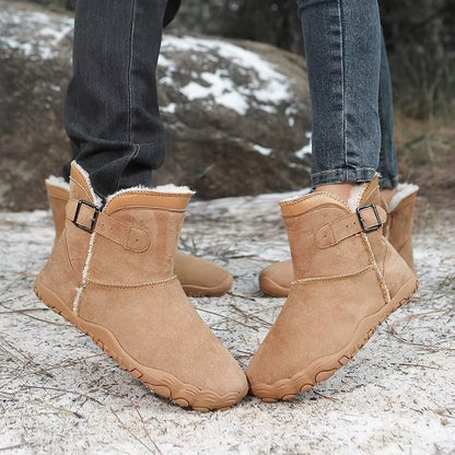 Ankle-height barefoot winter boots with faux fur lining, buckle strap and textured tread