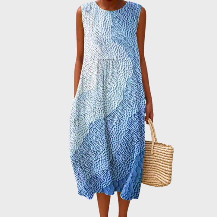 Women's sleeveless tiered midi dress in blue, yellow and green plaid colour block.