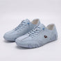 Low-top lace-up sneakers with round toes, stitched panels and segmented soles