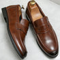 Men's penny loafers with almond toes and stitched apron detail