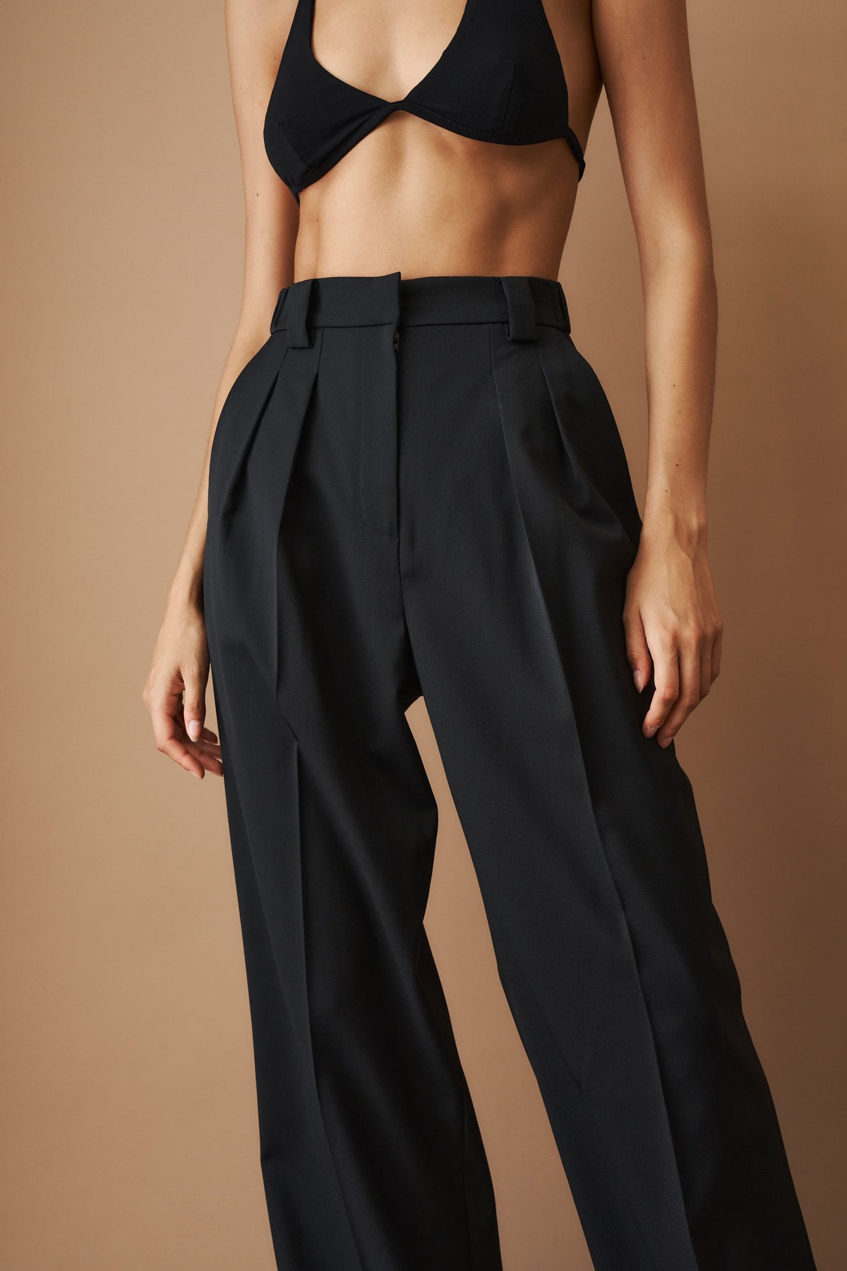 Women's black high-waisted wide-leg pleated pants with belt loops and side pockets