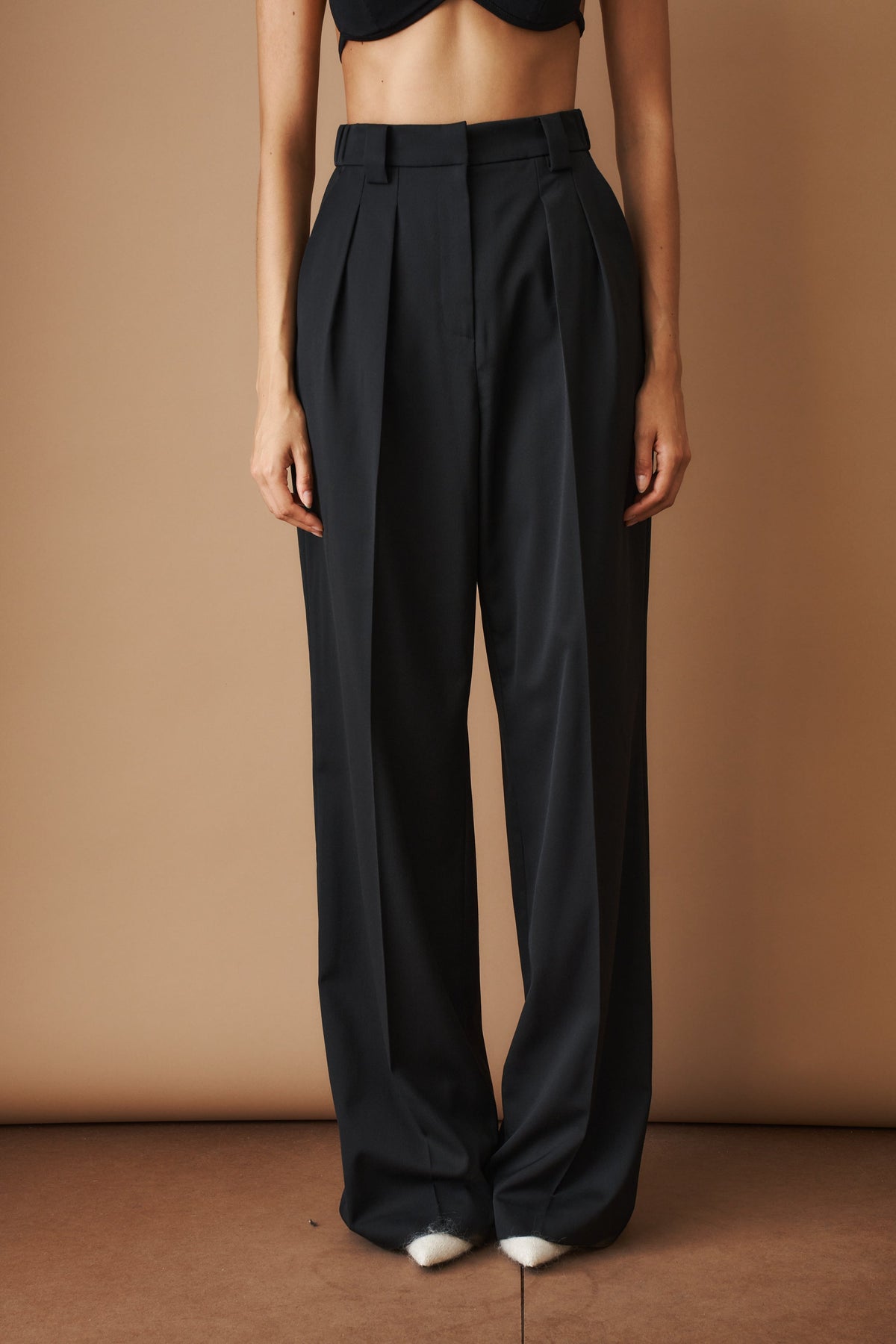 Women's black high-waisted wide-leg pleated pants with belt loops and side pockets