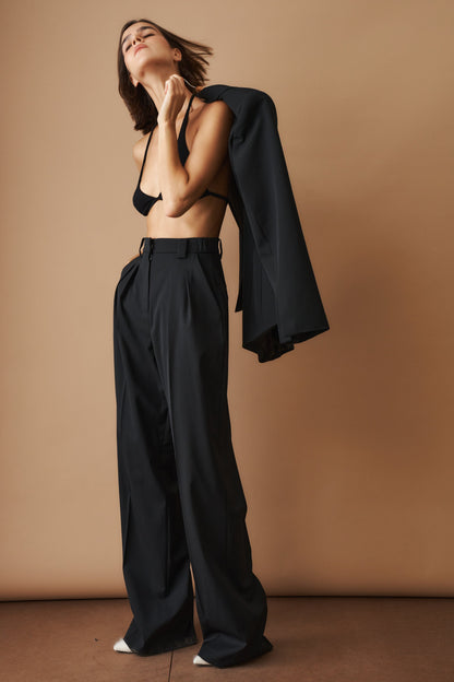 Women's black high-waisted wide-leg pleated pants with belt loops and side pockets