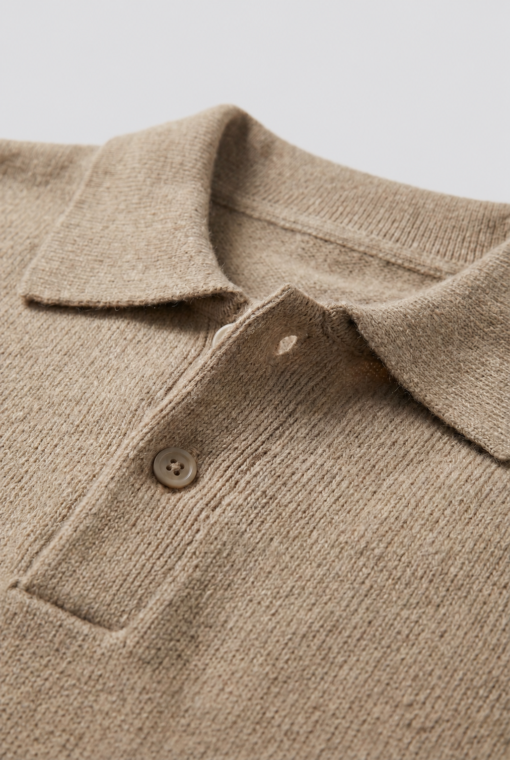 Men's black textured polo jumper with long sleeves and button placket