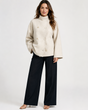Women's beige turtleneck coat with button front and long sleeves