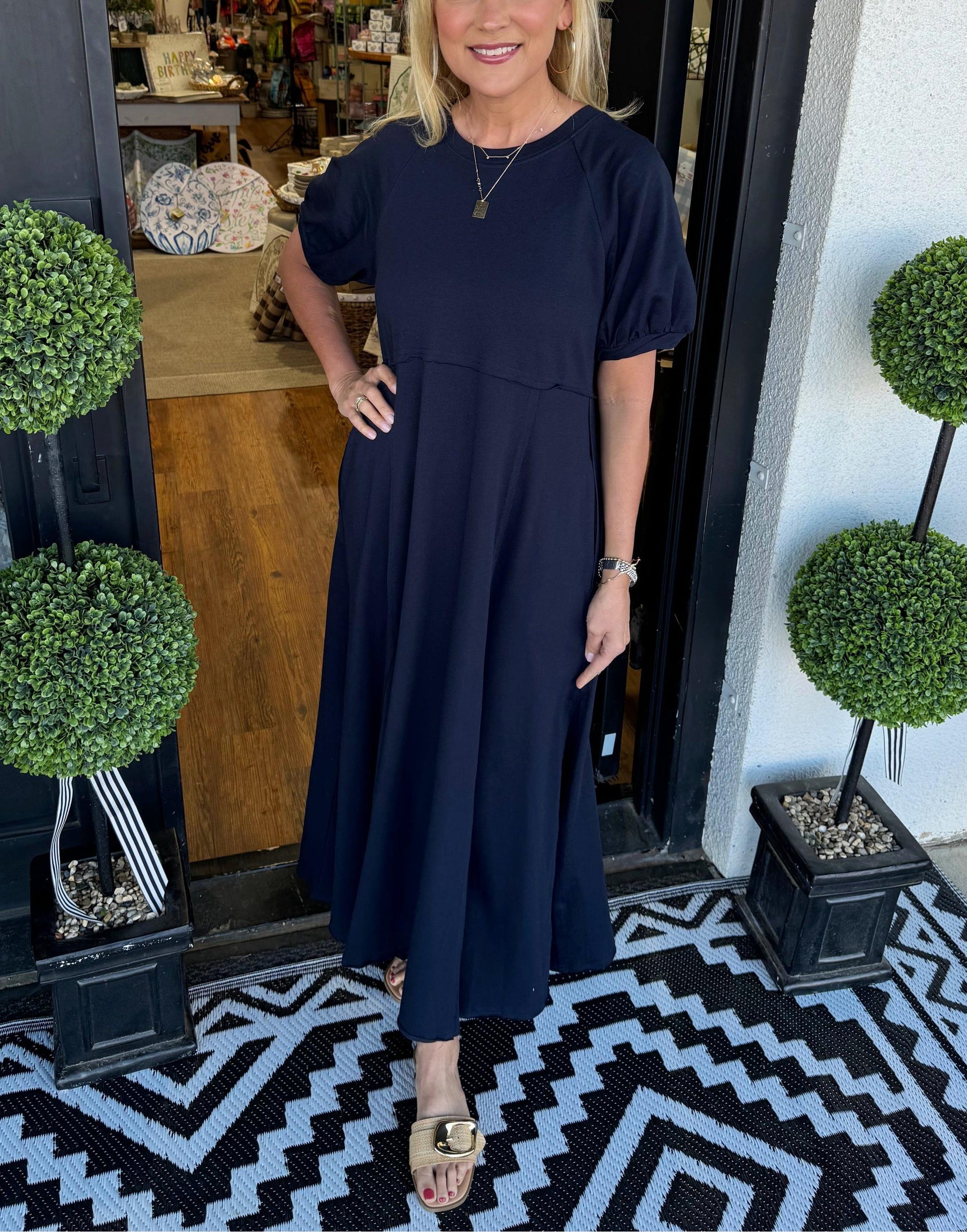 Front view of the Rhys navy puff sleeve maxi dress, showcasing the round neckline and relaxed silhouette.