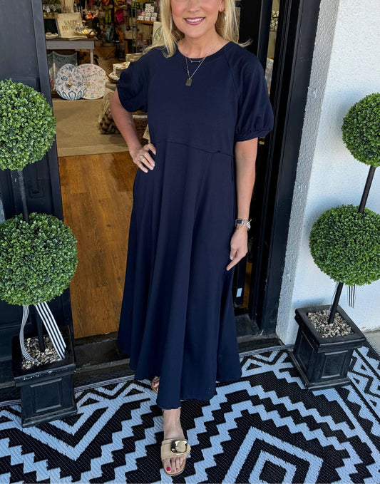 Front view of the Rhys navy puff sleeve maxi dress, showcasing the round neckline and relaxed silhouette.