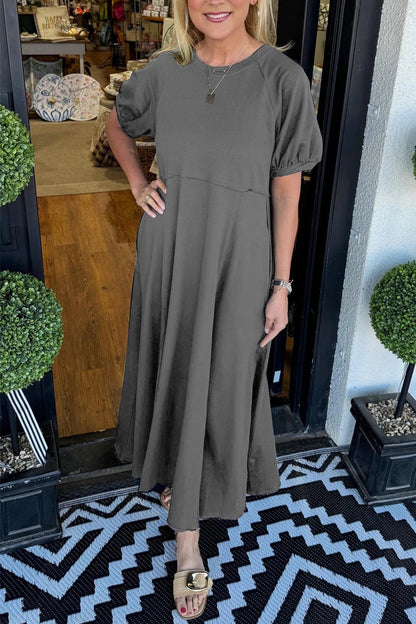 Close-up of the classic round neckline on the elegant navy puff sleeve maxi dress, perfect for accessorizing.