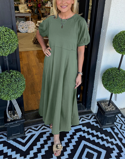 Back view of the solid navy blue puff sleeve maxi dress, emphasizing the graceful drape of the fabric.