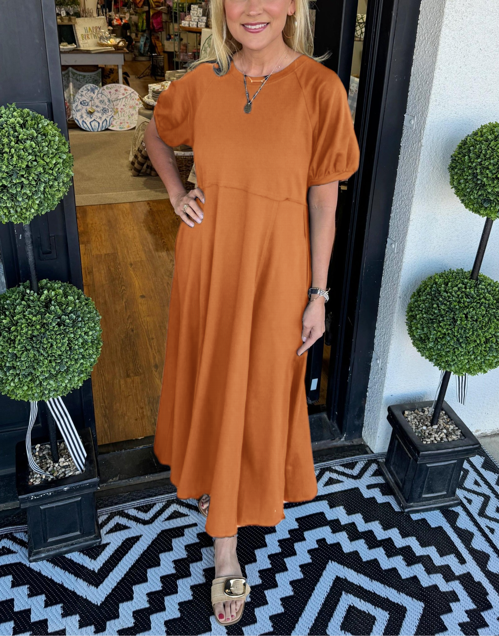 Lifestyle image of the navy puff sleeve maxi dress worn outdoors, illustrating its versatility and comfort.