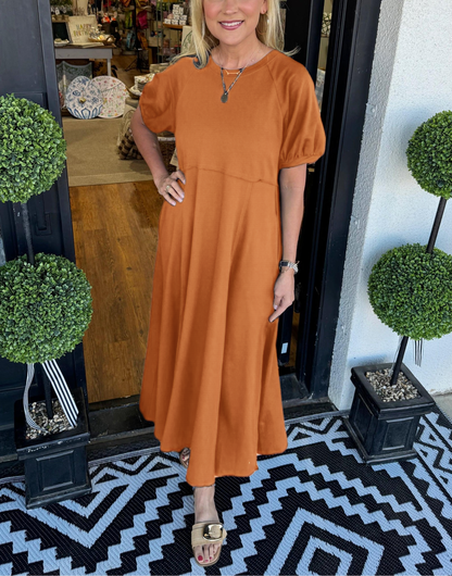 Lifestyle image of the navy puff sleeve maxi dress worn outdoors, illustrating its versatility and comfort.